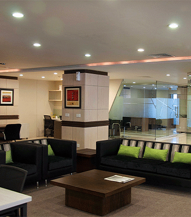 Modern living room with comfortable couches and tables.