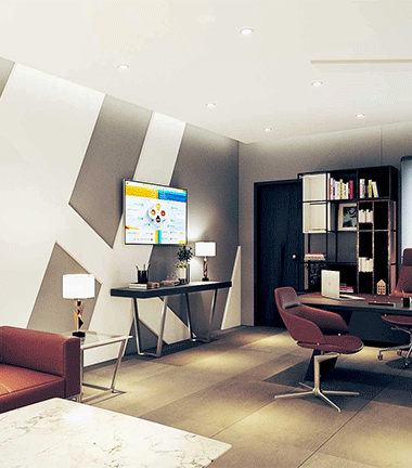 Stylish office with couch, desk, and TV setup.