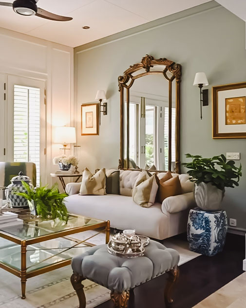Modern living room with large mirror above couch.
